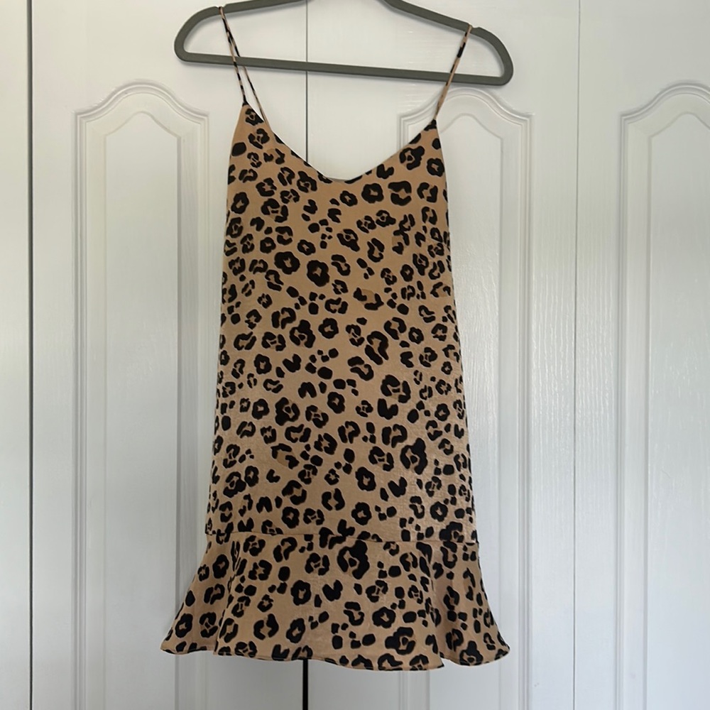 This is a satin material dress that is formfitting, but flowing on the end!